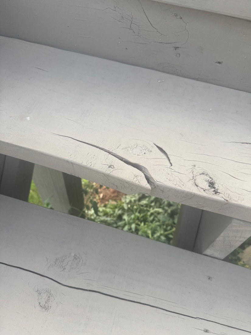 Close project photo showing a split and weathered wood railing