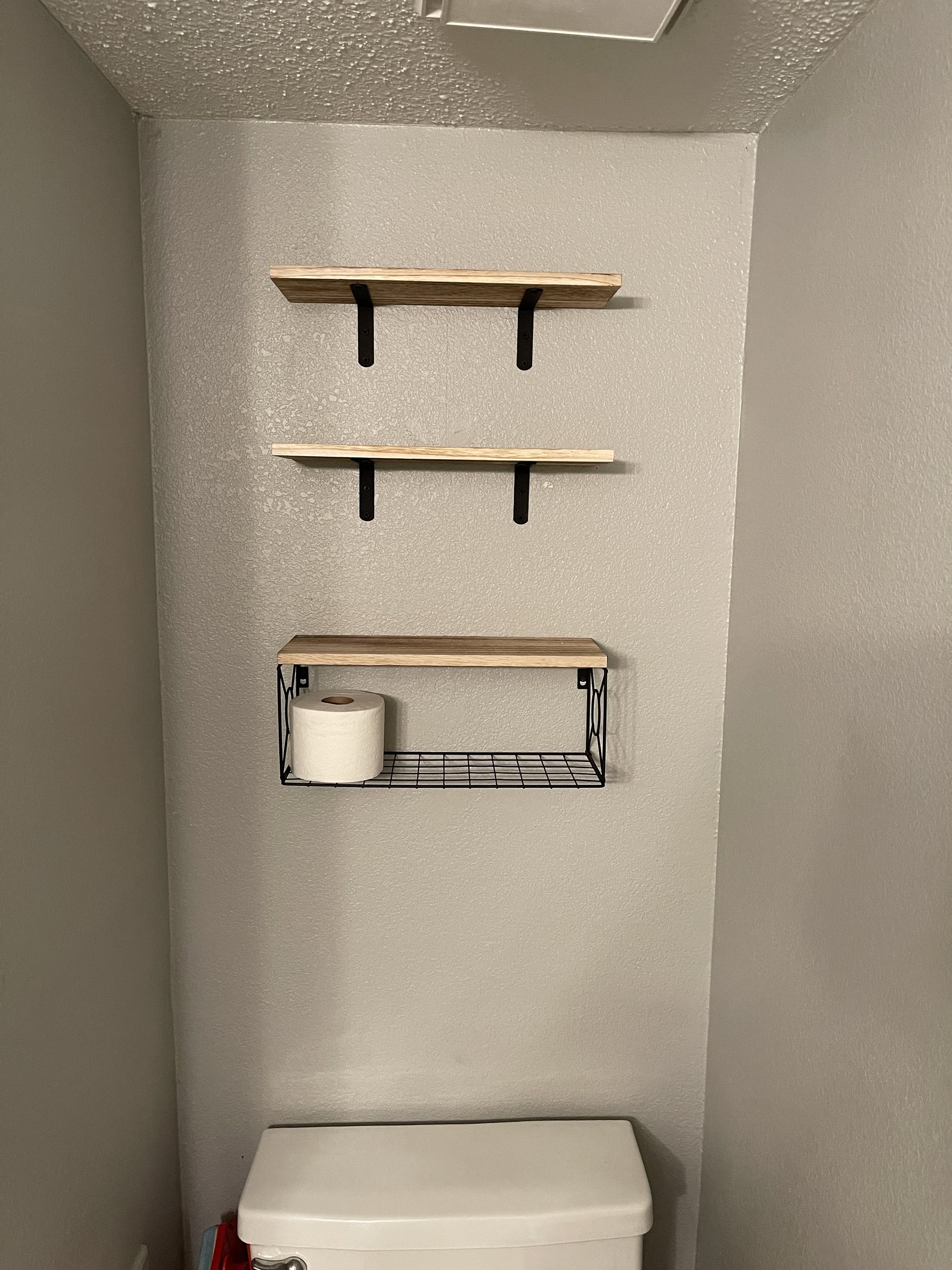 Wood shelves and bathroom storage mounted by Only Solutions